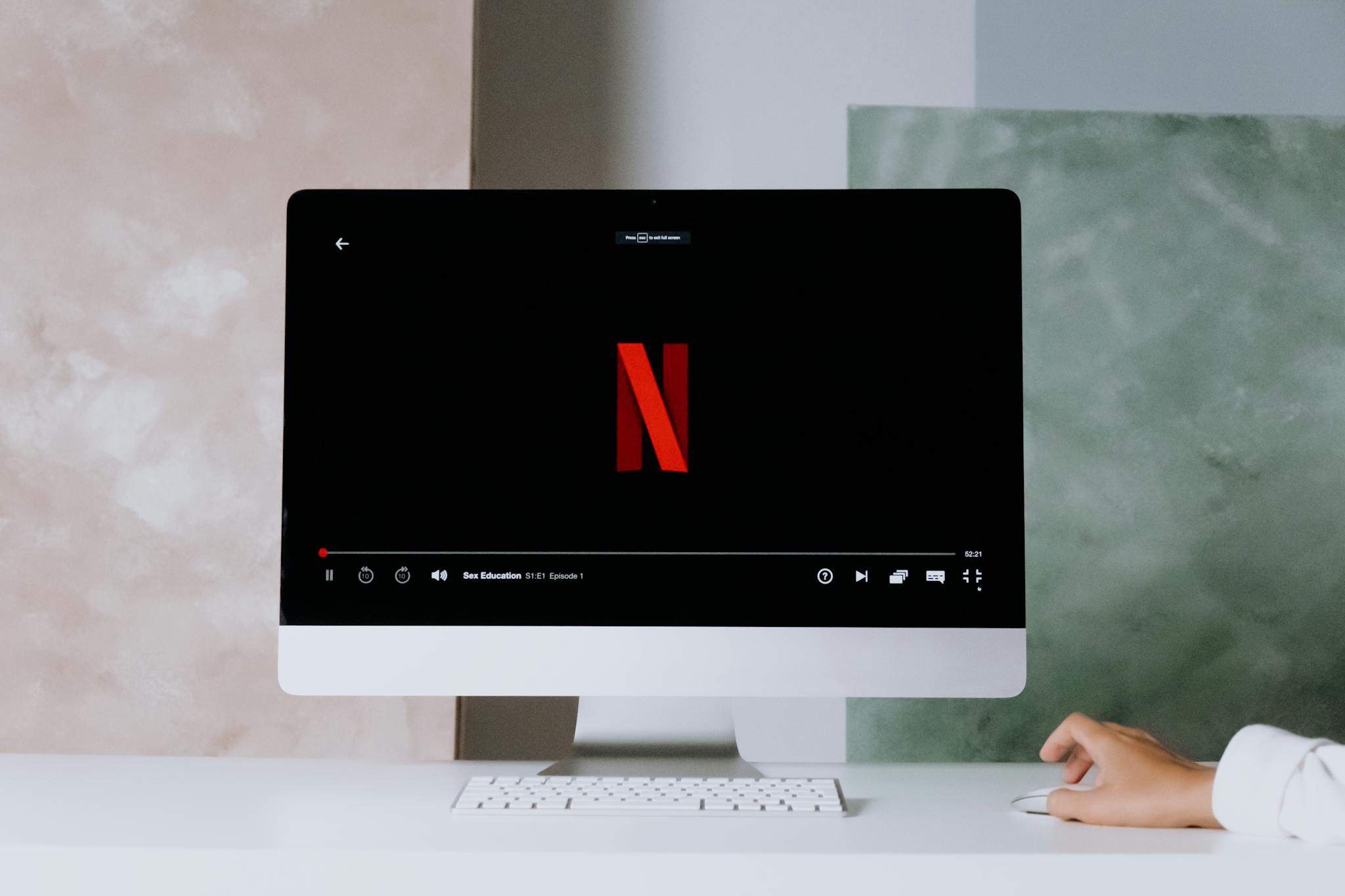 A minimalist workspace scene featuring a desktop displaying a streaming service, ideal for modern lifestyle themes.
